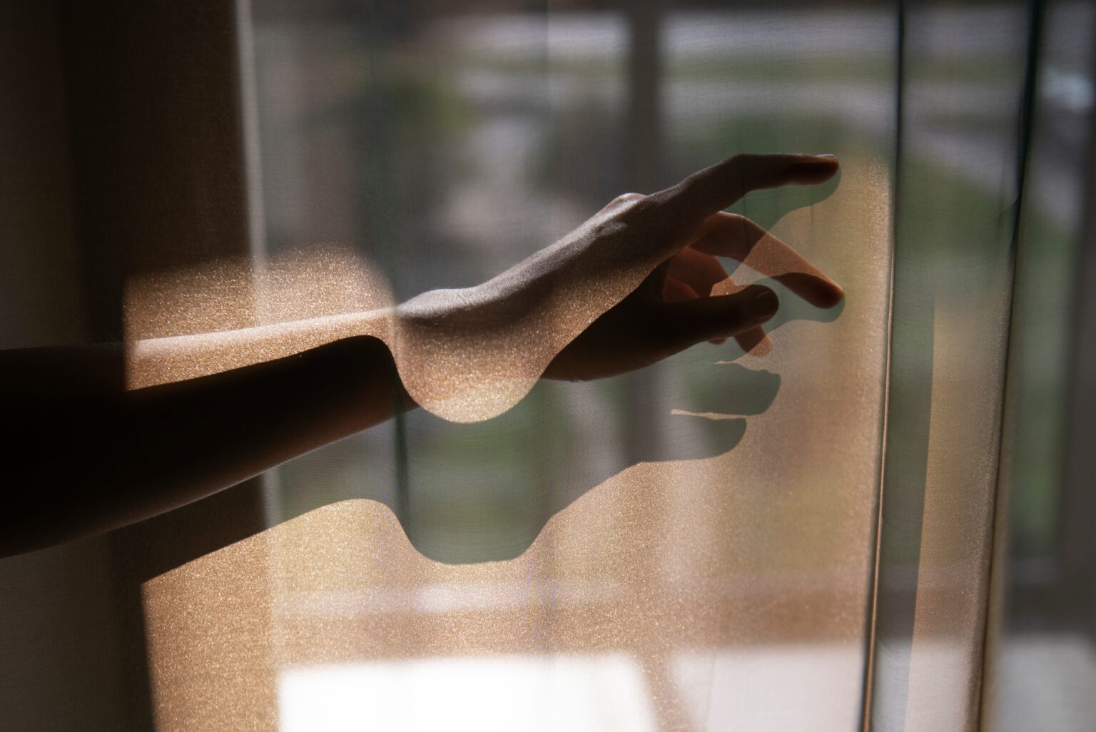 creative-view-hands-with-curtains-shadows-from-window
